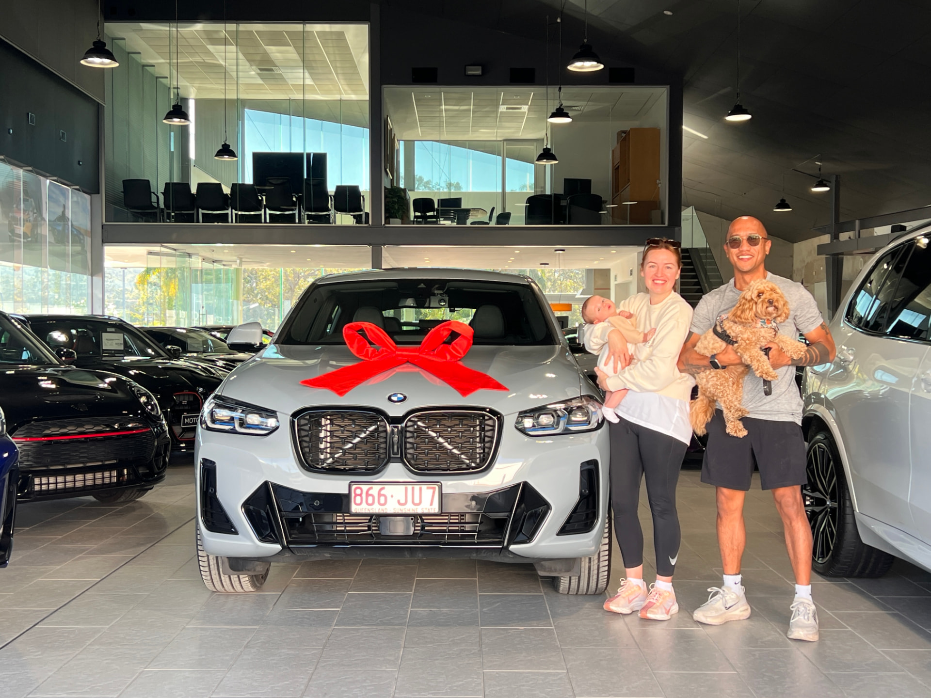 Family collecting their new BMW SUV, financed through Simple Loans