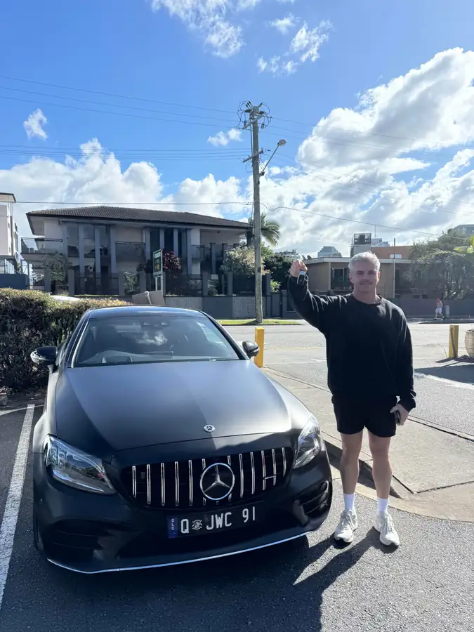 Customer holding the keys to their financed Mercedes-Benz