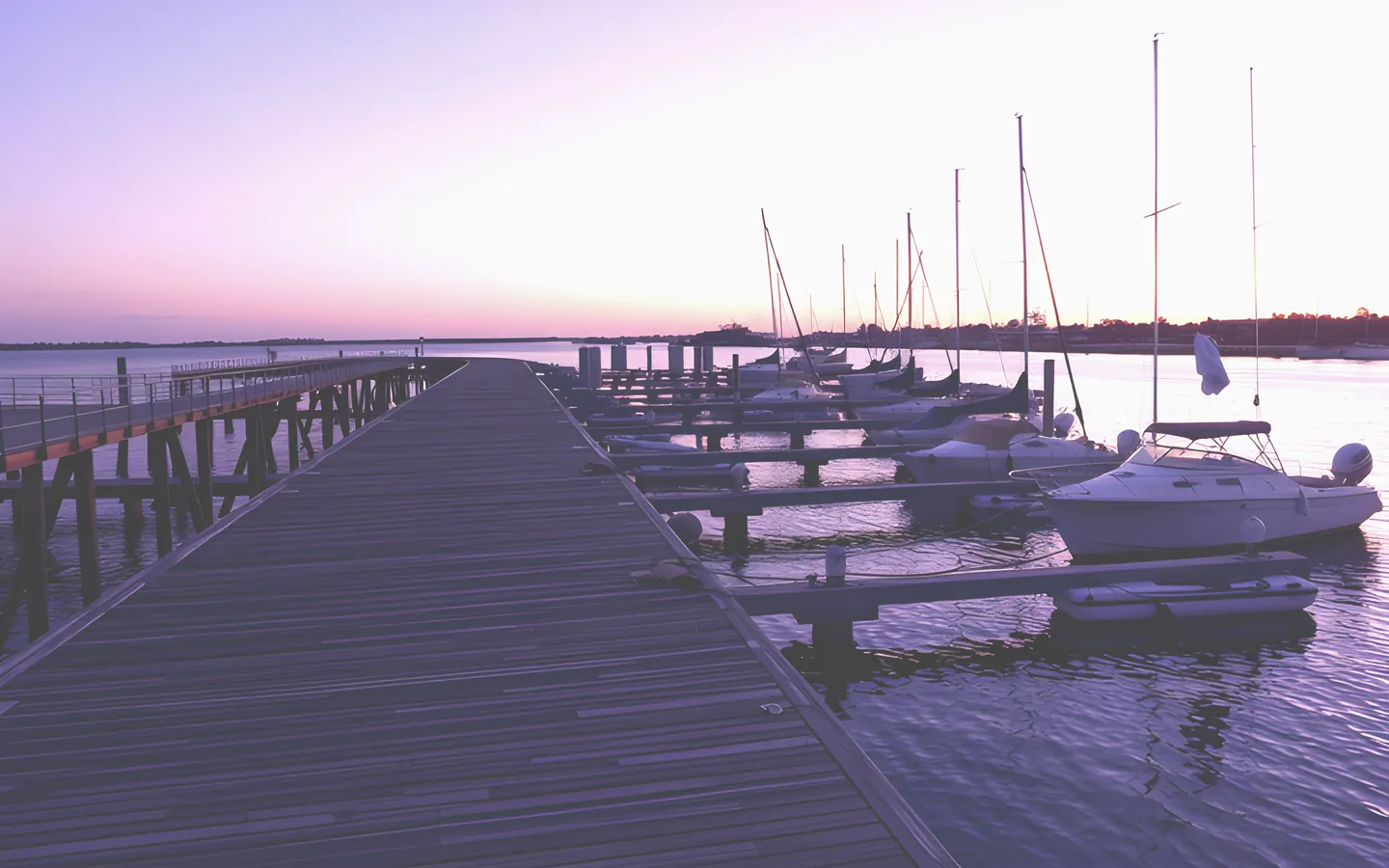 Mandurah estuary boardwalk and boats at sunset