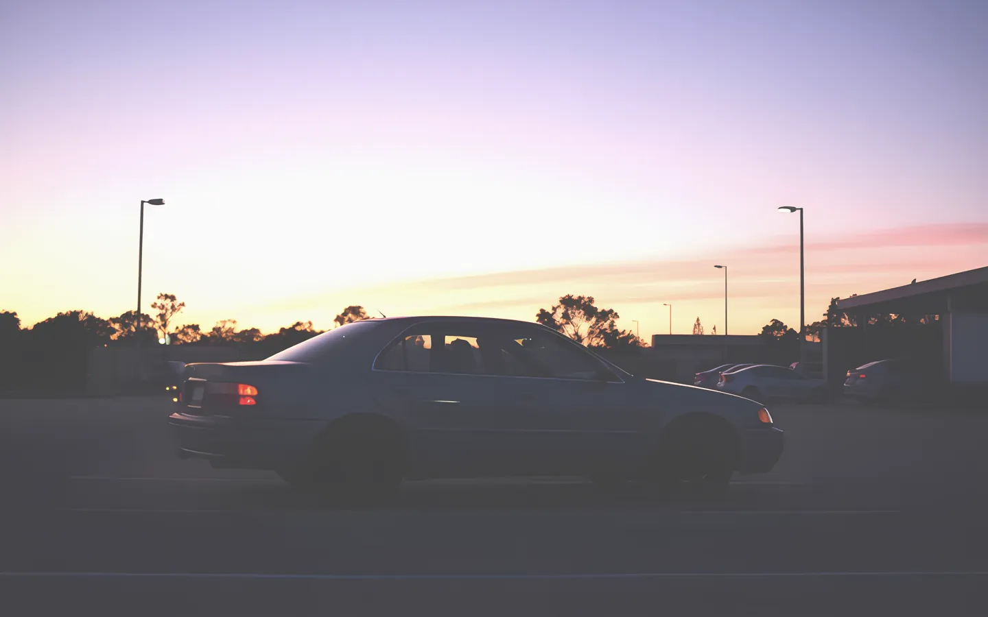 Mid size used sedan in a quiet Australian carpark at sunset