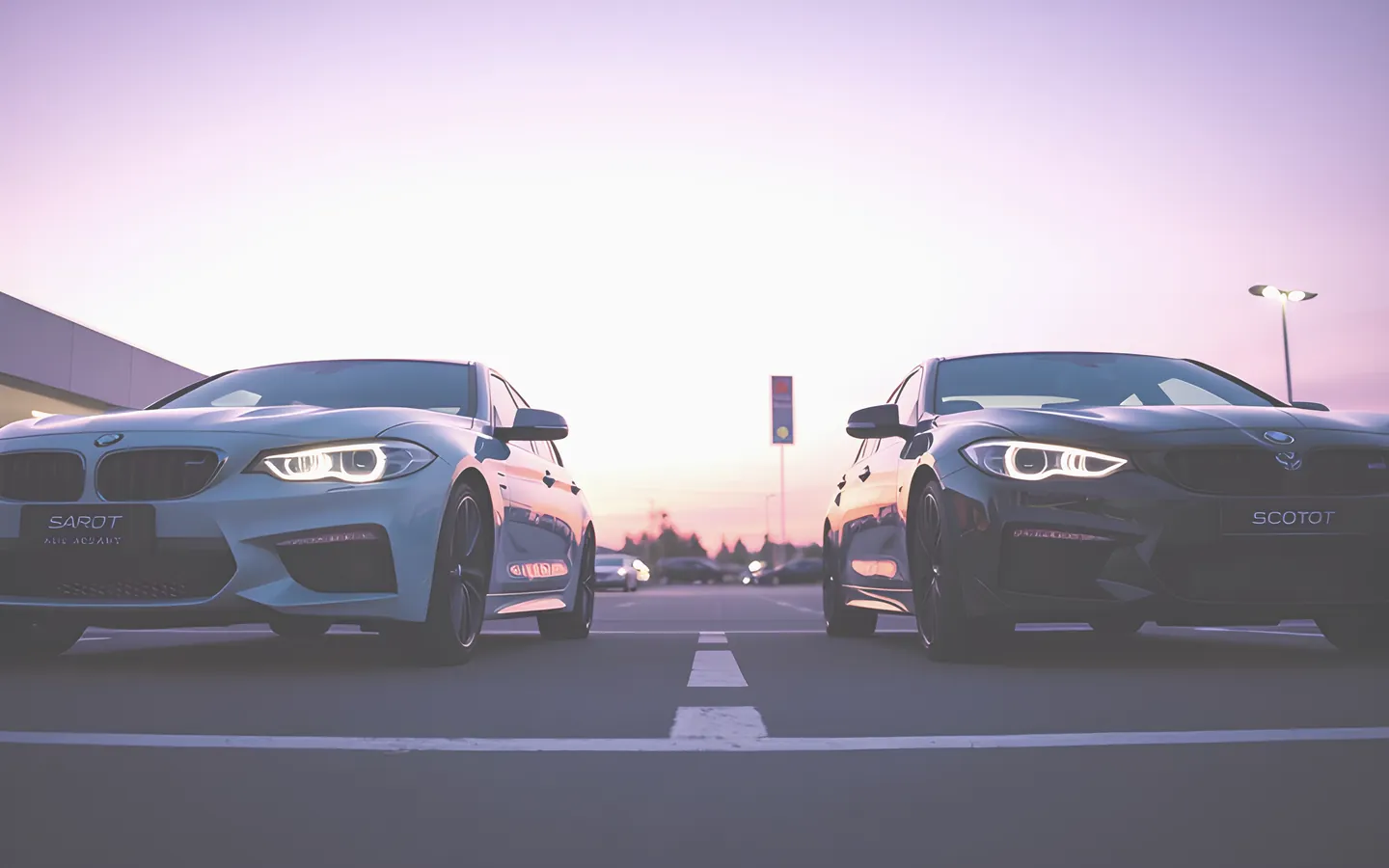 Two cars side by side on a dealership lot being compared