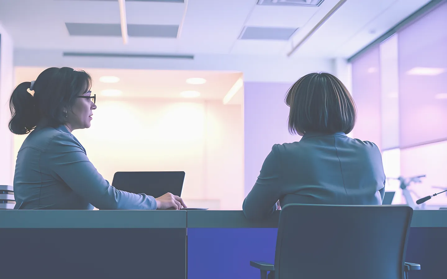 Specialist adviser explaining options to a customer at a desk